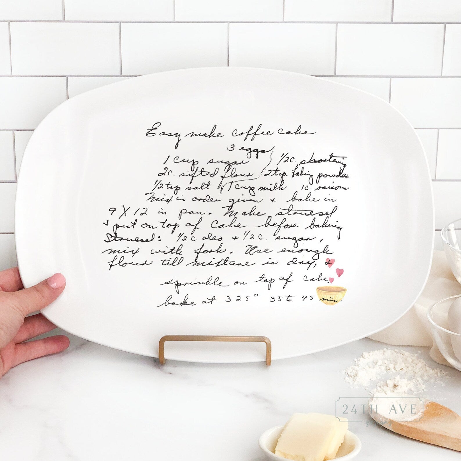 Personalized handwritten recipe platter displayed on stand featuring original family recipe and heart bowl accent.