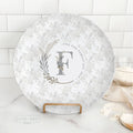 Boho floral monogram family name plate with personalized last name and established date displayed on kitchen counter