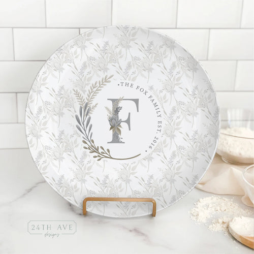 Boho floral monogram family name plate with personalized last name and established date displayed on kitchen counter