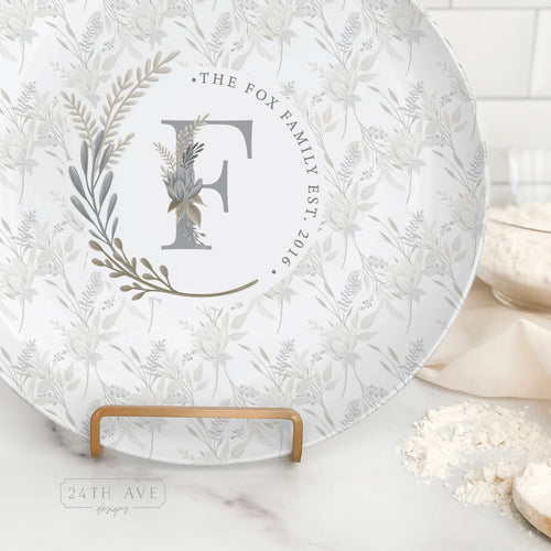 Close up of boho floral monogram personalized family name plate with established year detail